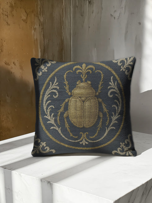 square woven tapestry pillow in charcoal grey and metallic gold thread, embodying a premium, artisan feel. The central design features a large, detailed scarab beetle, a key motif in entomology decor, encircled by ornate Victorian botanical flourishes. This combination of scholarly and mystical elements is ideal for Dark Academia, Gothic, and Whimsigoth aesthetics. The luxurious, double-sided piece of functional art is perfect as a statement pillow for a library or reading nook.